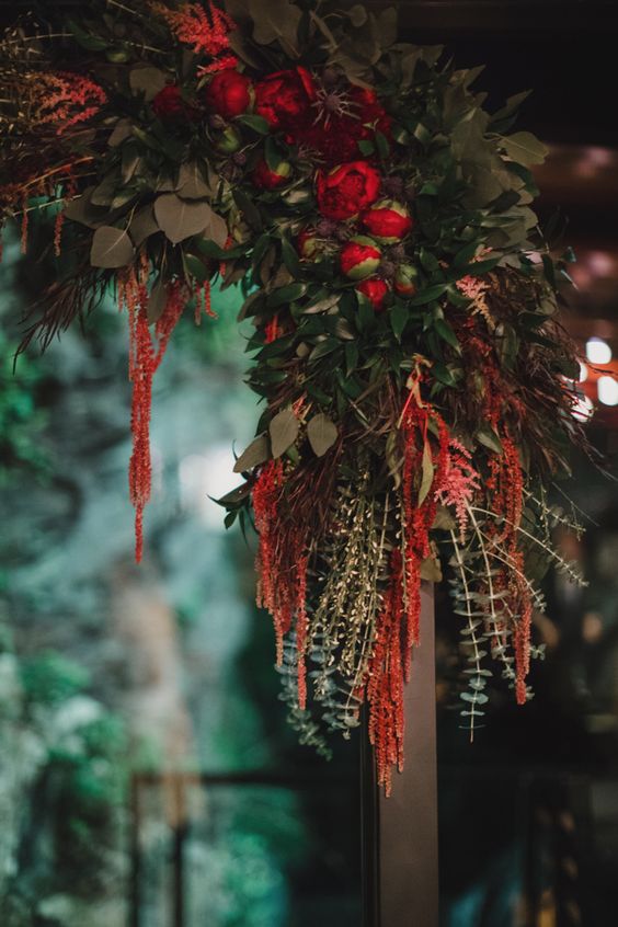 a chic and refined wedding arch styled with greenery, thistles, red, burgundy blooms and amaranthus is a gorgeous idea for the fall