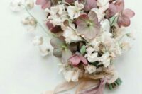 a chic wedding bouquet of blush sweet peas and dark blooms for a contrast, mauve and neutral ribbons is refined