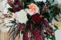 a chic wedding bouquet of white and burgundy blooms, berries, foliage and amaranthus is a cool idea for a fall or winter wedding