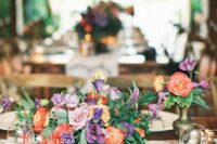 a colorful summer wedding arrangement of purple, red and lilac blooms and foliage is very vibrant