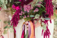 a colorful wedding bouquet of amaranthus, burgundy mums, hot pink peony roses, greenery and berries is amazing for summer or fall