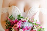 a colorful wedding bouquet of bougainvillea, blue hydrangeas, white and pink roses and greenery plus astilbe for a bold wedding