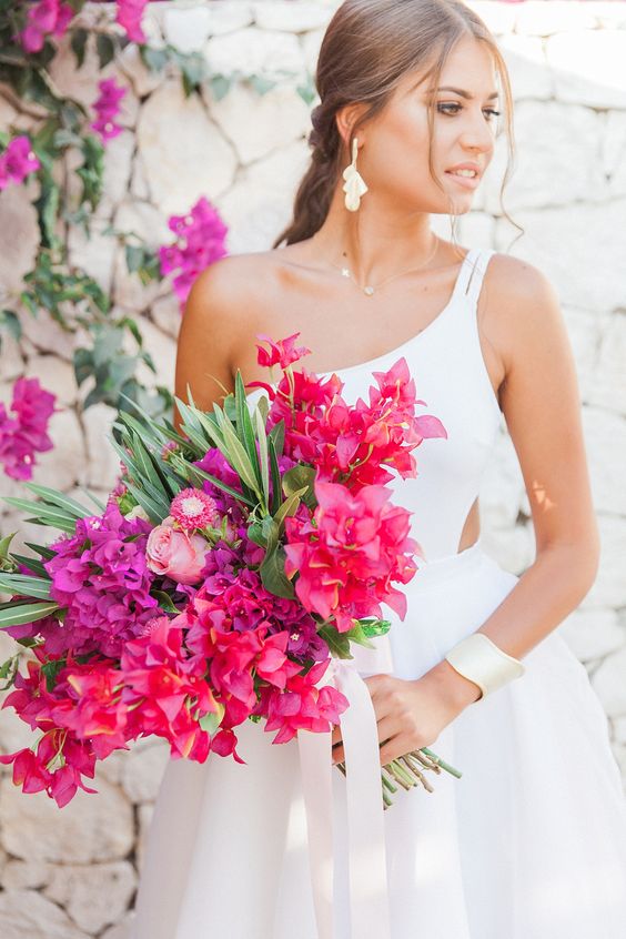 a colorful wedding bouquet of bougainvillea, pink roses and greenery is a super chic idea for a Mediterranean wedding