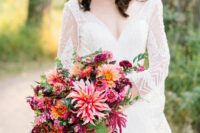a colorful wedding bouquet of pink, peachy pink and fuchsia blooms, orange ones, greenery and amaranthus is amazing for the fall