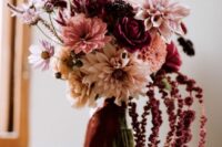 a contrasting wedding bouquet of blush and pink blooms plus mauve and burgundy ones and amaranthus for an eye-catching element