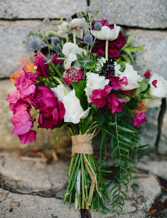 a contrasting wedding bouquet of bougainvillea, white roses, thistles, greenery is a stunning idea for a fall wedding