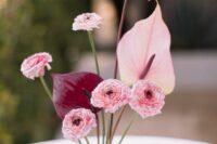 a contrasting wedding centerpiece of anthuriums and carnations is a cool idea for a modern wedding