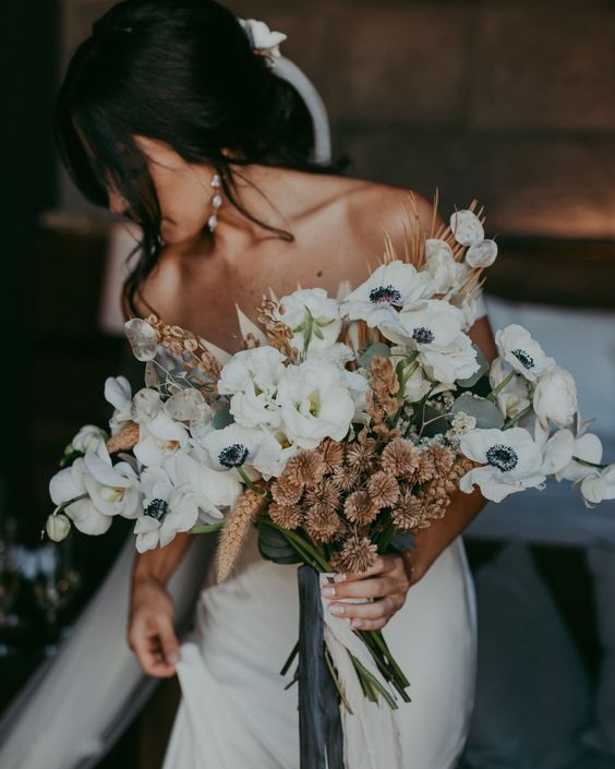 a cool wedding bouquet of white anemones, lunaria, dried grasses and allium is a lovely idea for a boho bride who loves neutrals