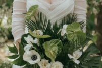 a cool wedding bouquet of white roses and anemones, green anthurium, fronds and leaves for a tropical wedding