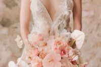 a delicate wedding bouquet of blush anthurium, roses and carnations, lunaria, feathers and orchids is a chic and lovely solution