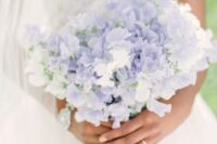 a delicate wedding bouquet of lilac and white sweet peas is a chic idea for a spring wedding done in a pastel color palette