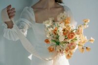 a delicate wedding bouquet of neutral sweet peas and peachy ranunculus is a great idea for a spring or summer bride
