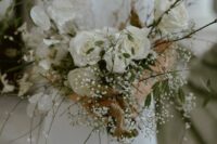 a delicate wedding bouquet of white roses, lunaria, some baby’s breath, twigs and greenery is a relaxed and cool idea for spring
