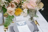 a fab wedding centerpiece of white and blush roses, fronds, leaves, blush anthuriums and a gold geometric piece