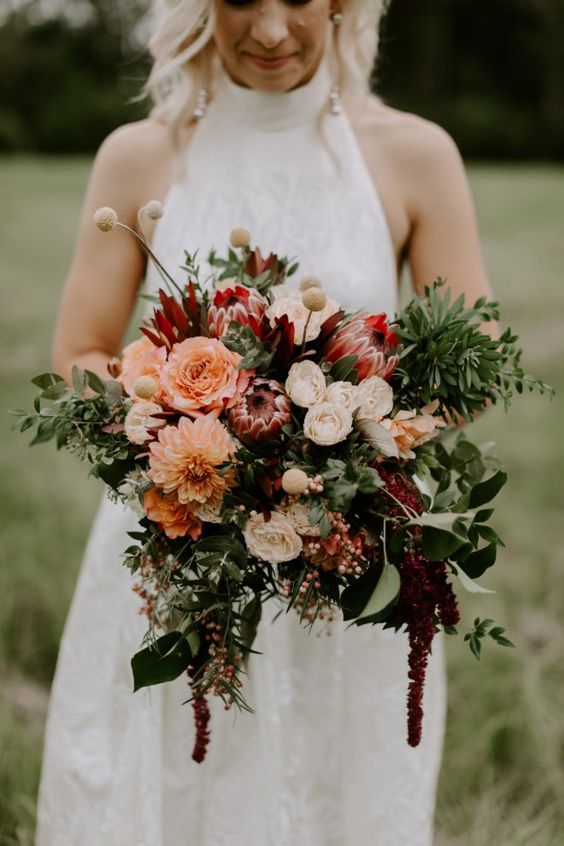 a fall wedding bouquet of peachy, white and pink blooms, greenery, berries and amaranthus and billy balls is a catchy idea