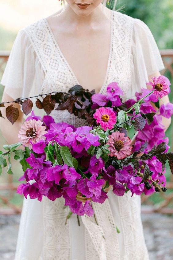 a fantastic bougainvillea wedding bouquet with some other matching blooms, greenery and dark foliage is a stunning idea
