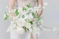 a gorgeous all-white wedding bouquet with blooming branches and greenery is a chic idea for a spring or summer bride