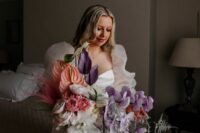 a jaw-dropping wedding bouquet of lilac orchids, lilac and peachy anthurium, white and blush blooms, grasses and leaves