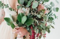 a large wedding bouquet of greenery, king proteas and amaranthus is amazing for a fall or summer wedding