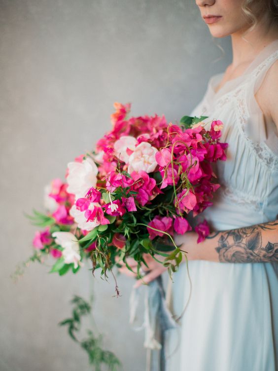 a lovely bougainvillea wedding bouquet with blush peonies and some cascading greenery is a chic and cool idea for a summer bride