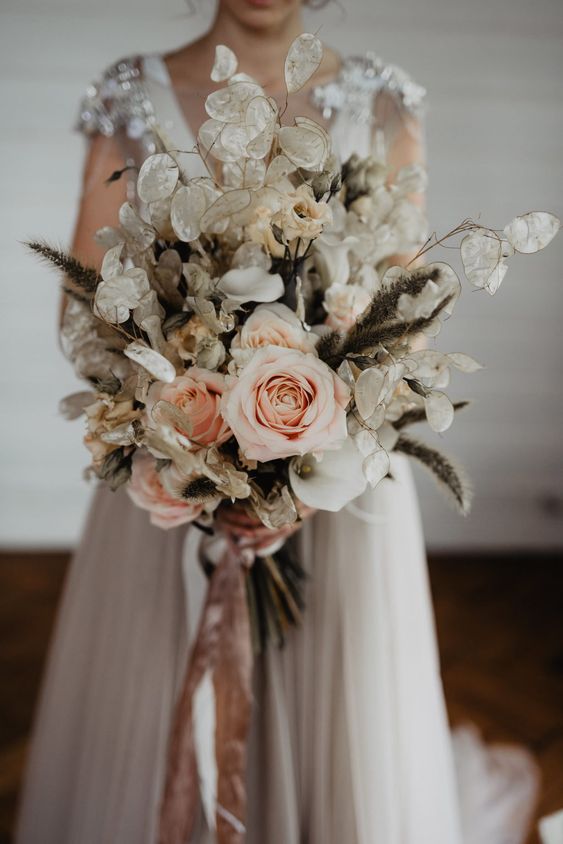 a lovely wedding bouquet of lunaria, blush roses and some grasses is a super catchy and unusual idea for a wedding