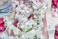 a lovely wedding centerpiece of a stand with test tubes and sweet peas – make several ones and create an ombre effect