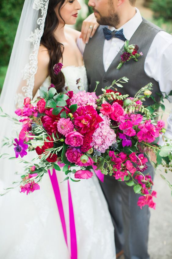 a lush and dimensional wedding bouquet of hydrangeas, peonues, mums, ranunculus and bougainvillea plus greenery is wow