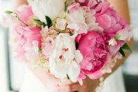 a lush wedding bouquet of white and pink peonies and white and pink sweet peas is a gorgeous idea for spring or summer