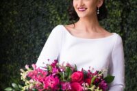 a modern jewel-tone wedding bouquet of fuchsia and pink roses and peonies, bougainvillea and greenery for a chic modern wedding