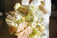 a neutral wedding bouquet of white blooms, roses and others plus blush anthurium is a spectacular idea
