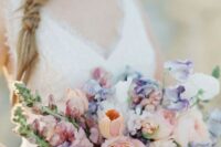 a pastel spring wedding bouquet with peachy and purple blooms for a romantic spring bride