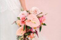 a pink wedding bouquet of anthurium, roses and some smaller mauve fillers for a pink-colored wedding