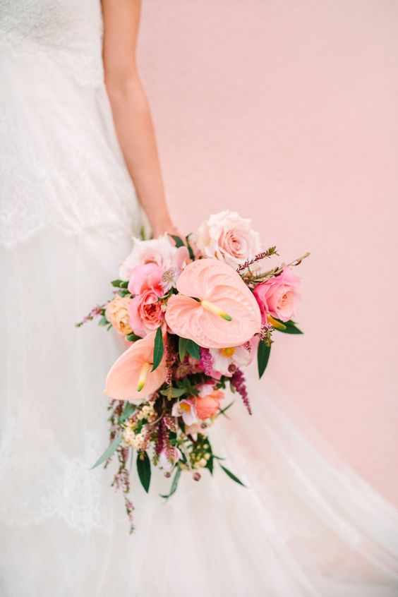 a pink wedding bouquet of anthurium, roses and some smaller mauve fillers for a pink-colored wedding