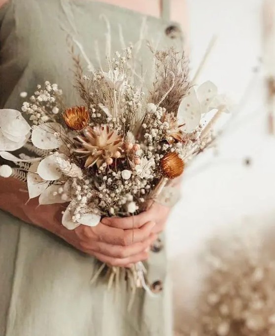 a pretty dried wedding bouquet of lunaria, pampas grass, baby's breath, dried daises and fern is a lovely idea for both a bride or bridesmaid