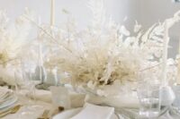 a really ethereal dried leaf wedding centerpiece with lunaria is ideal for an all-white wedding tablescape and it looks chic and elegant