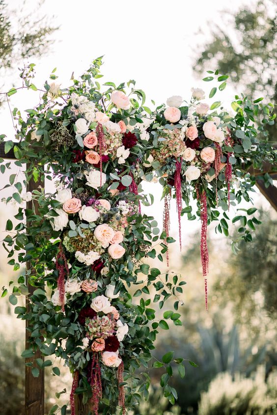 a refined fall wedding arch with greenery, blush, white and burgundy roses and amaranthus is a stylish and chic idea
