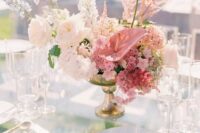 a refined wedding centerpiece of white roses, pink anthurium and other blooms and fillers is a gorgeous idea