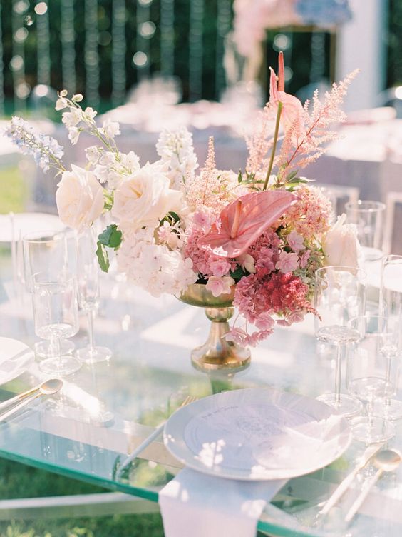 a refined wedding centerpiece of white roses, pink anthurium and other blooms and fillers is a gorgeous idea