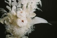 a refined white wedding bouquet of ponies, lunaria, dried leaves and grasses, some baby’s breath and a white burlap wrap