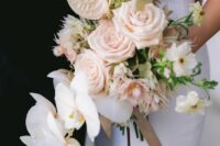 a romantic cascading wedding bouquet of blush anthurium, roses and some other blooms including white orchids