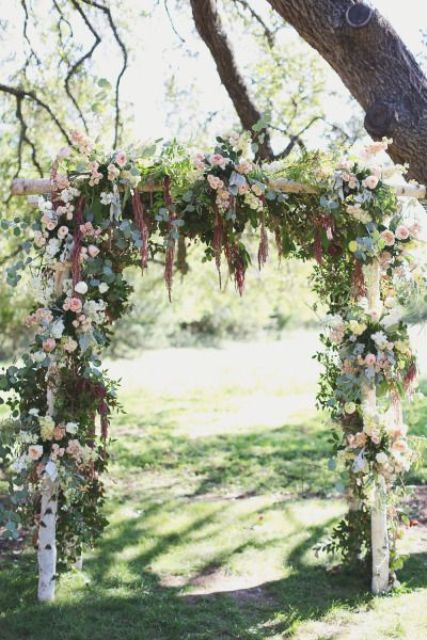 a rustic wedding arch of white, blush blooms, greenery and amaranthus is a cool and cozy idea for a rustic wedding
