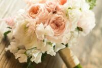 a rustic wedding bouquet of white and blush peony roses and white sweet peas, astilbe plus a wrap is a cool idea for spring or summer