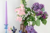 a simple and catchy wedding centerpiece of pink sweet peas and lilac, greenery and some bulbs plus a lilac candle is cool