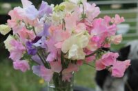 a simple wedding centerpiece of colorful sweet peas can be easily repeated and used for a spring or summer wedding