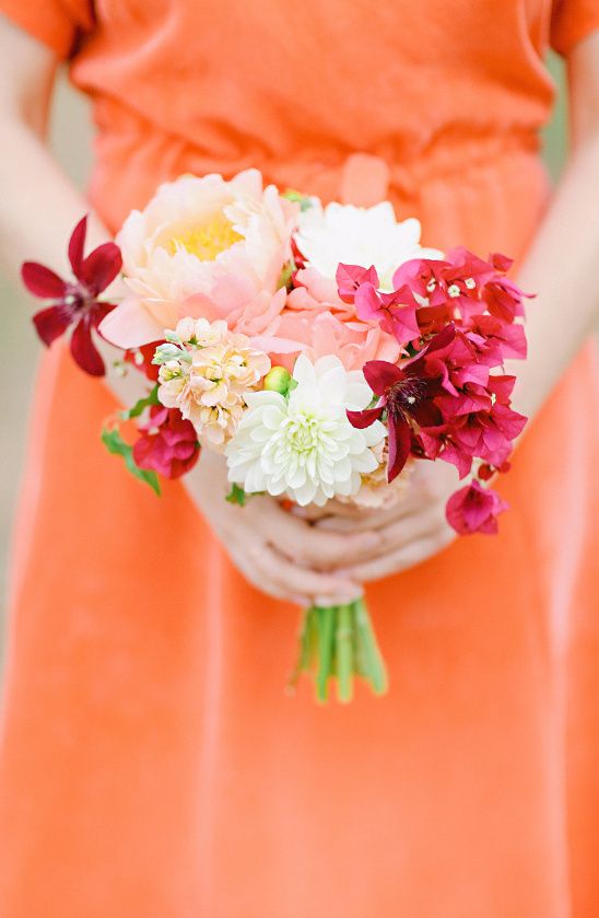a small and cool wedding bouquet of white dahlias, blush peonies, bougainvillea for a bold tropical wedding