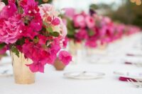 a small and cool wedding centerpiece of bougainvillea, blush blooms and greenery is a cool idea for a bright wedding