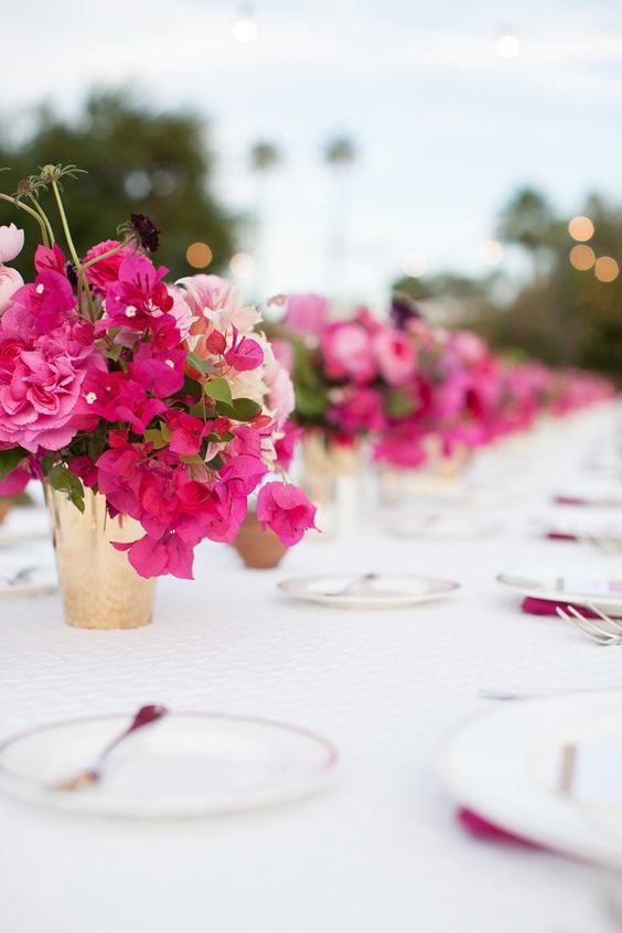 a small and cool wedding centerpiece of bougainvillea, blush blooms and greenery is a cool idea for a bright wedding