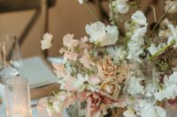 a sophisticated and chic wedding centerpiec eof peachy roses, orchids, blush and white sweet pears is adorable