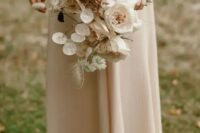 a sophisticated wedding bouquet with lunaria, dried herbs, blush and white blooms is beautiful for a fall wedding