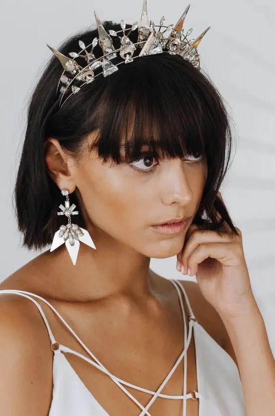 a statement crystal crown with spikes and matching spike earrings to accent an ultra-modern and minimalist bridal look
